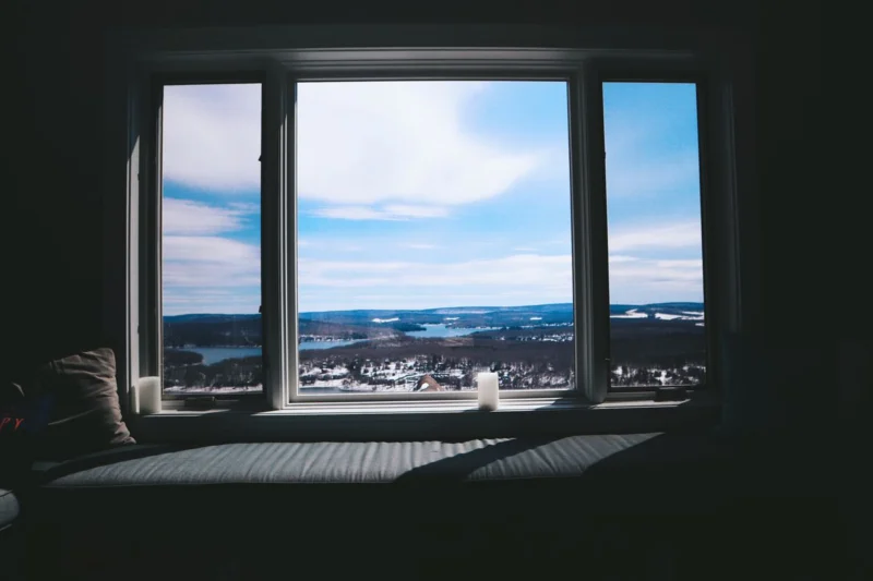 Large window with a deep sill looking out on a winter landscape
